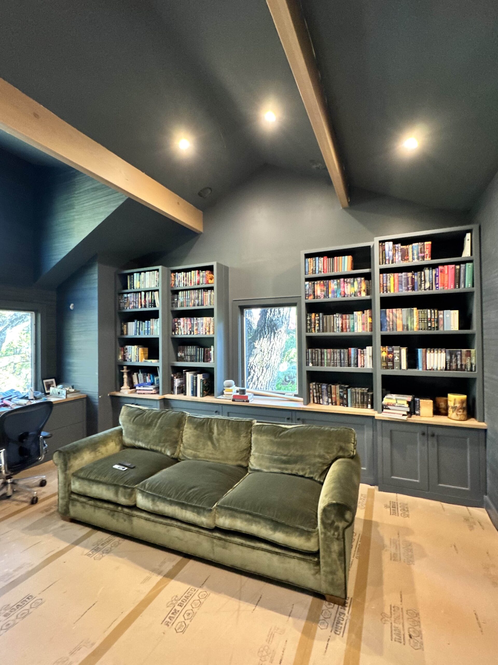 Recessed ceiling lights in a room with built-in bookshelves