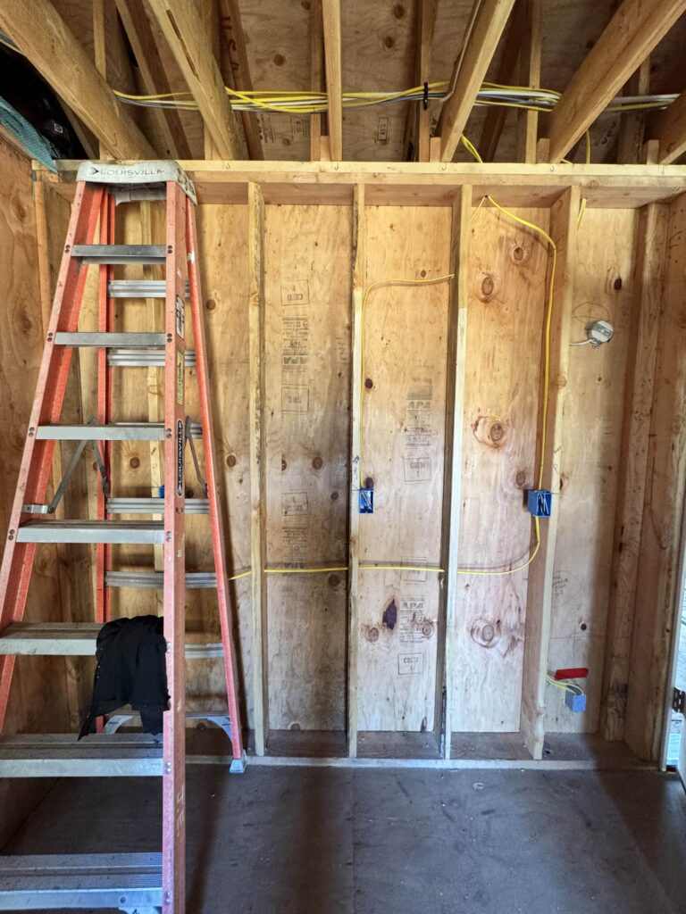Electrical rough-in wiring in exposed wall framing