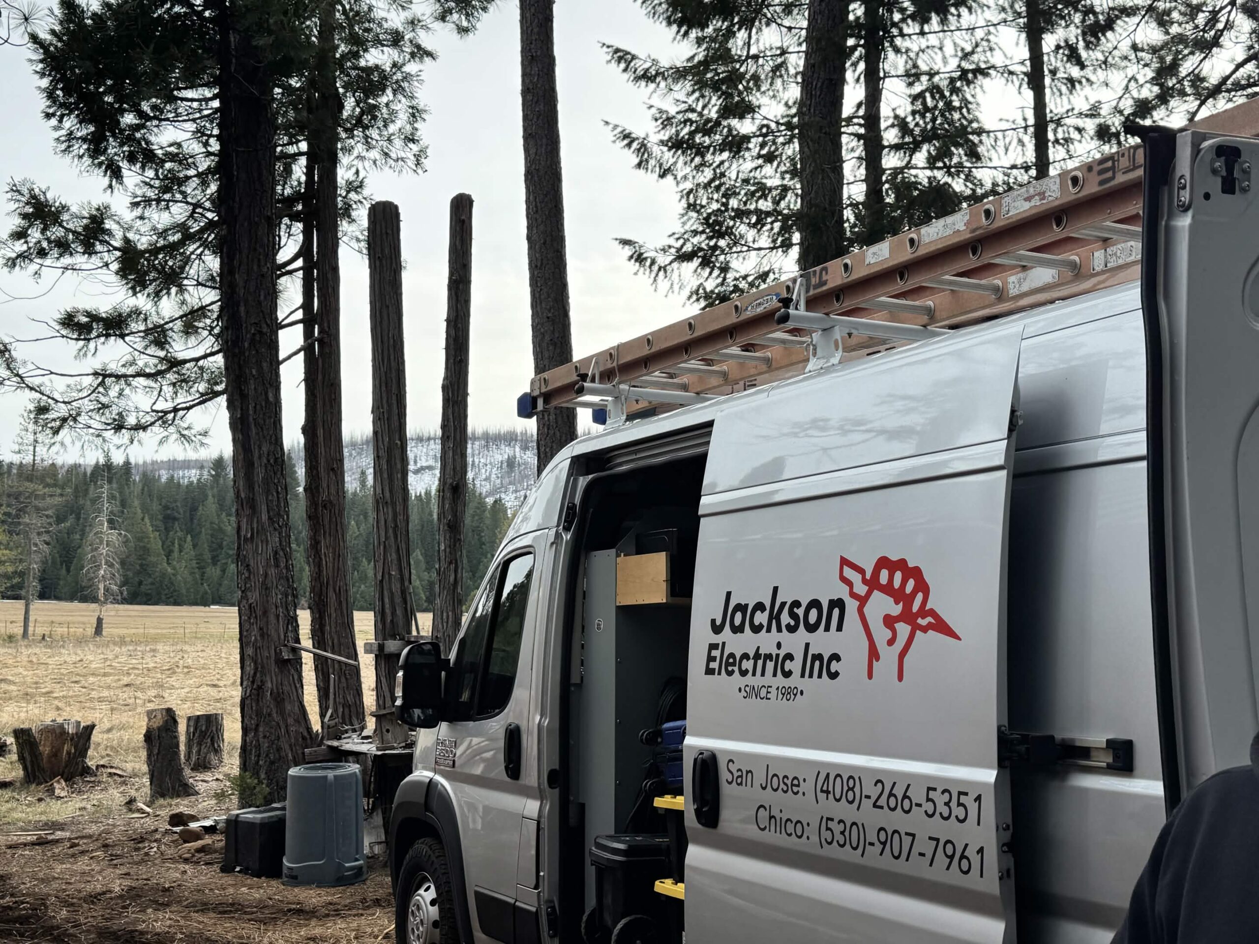Jackson Electric service van with ladders and company signage